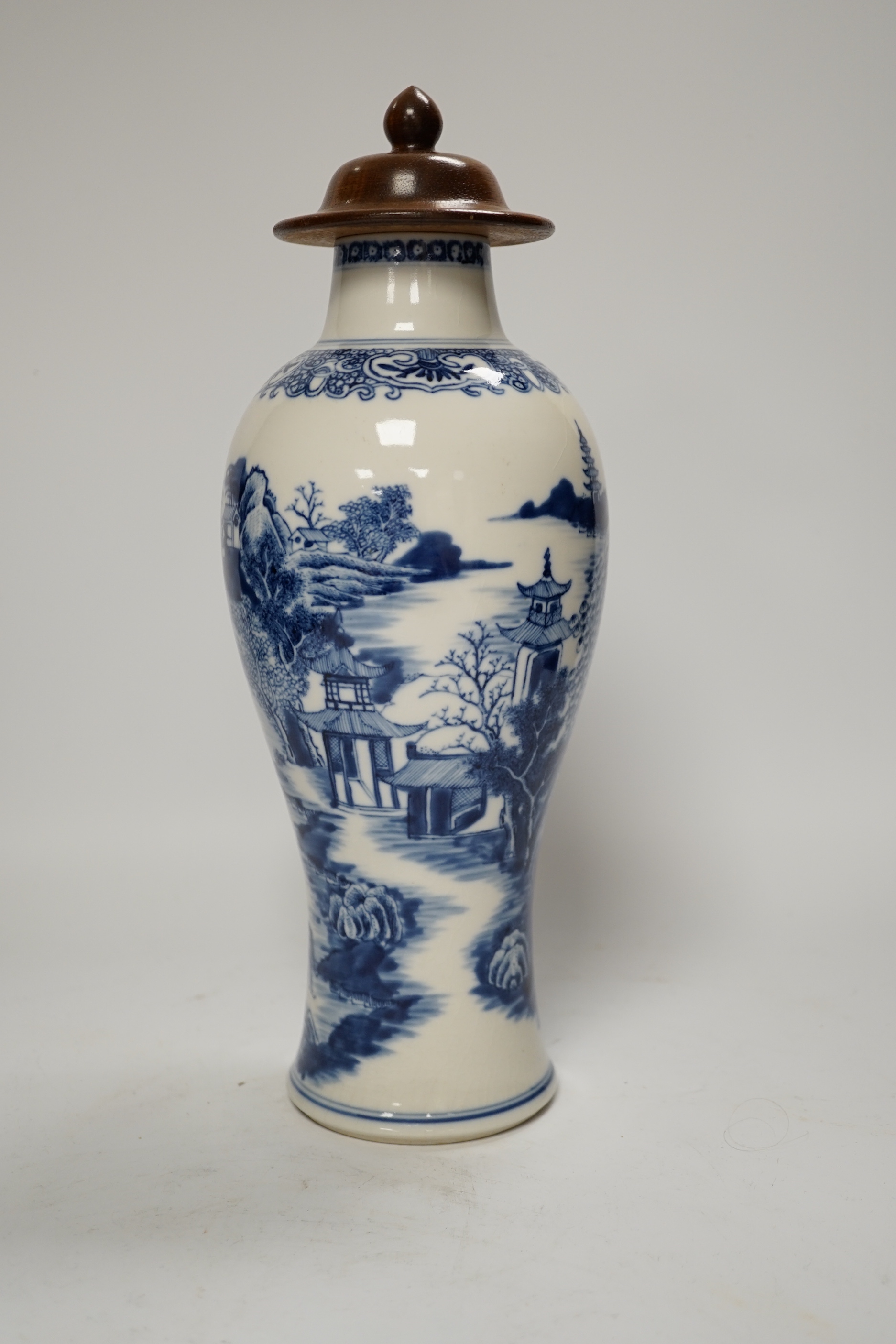 A Chinese Qianlong blue and white vase with wooden cover, 31.5cm